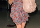 Eva Mendes wearing a pretty floral dress with trendy wedge shoes